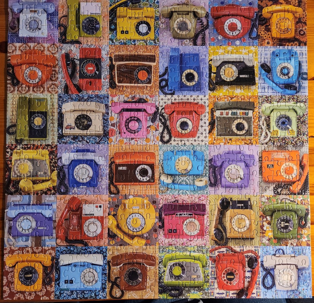 Completed puzzle showing various old telephones